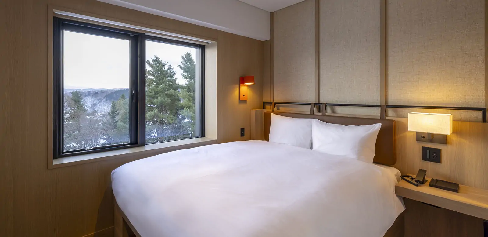 Modern hotel room with large window and nature view at Nozohotel