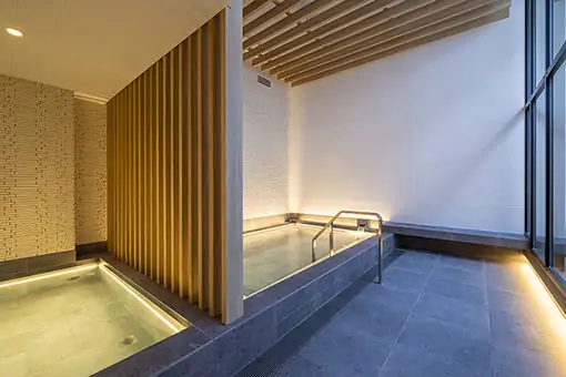 Elegant onsen bath at Nozo Hotel Furano with minimalist design and tranquil ambiance