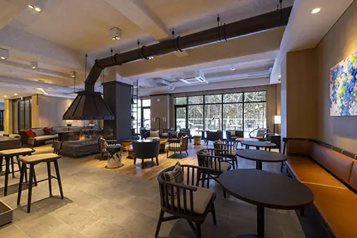 Cozy and stylish hotel restaurant interior with modern furnishings at Nozo Hotel Furano
