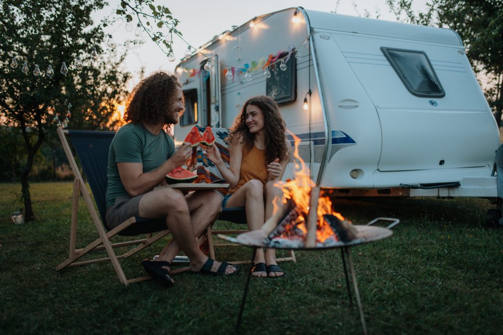 Couple,Having,Romantic,Picnic,During,Camping,Trip,In,Nature,,Eating