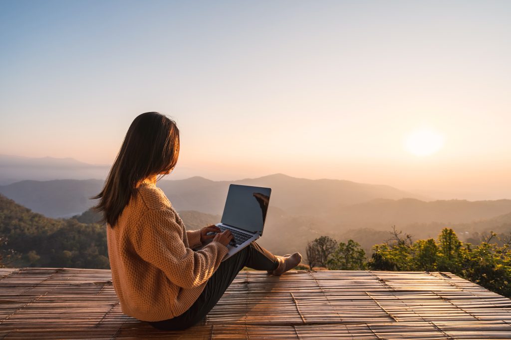 Young,Woman,Freelancer,Traveler,Working,Online,Using,Laptop,And,Enjoying